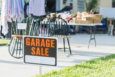 Garage sale outside with garage sale sign in front